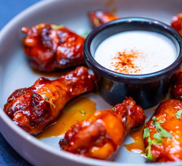 Saucy chicken wings with a dipping sauce