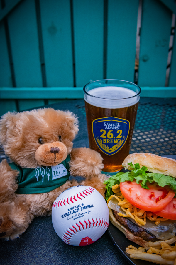 A stuffed toy bear, a baseball, a glass of beer, and a burger