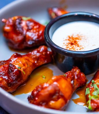 Saucy chicken wings with a dipping sauce